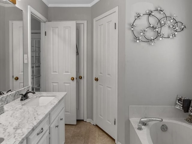 bathroom featuring ornamental molding, tile patterned floors, vanity, and a bathing tub