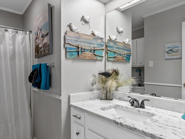 bathroom featuring ornamental molding and vanity