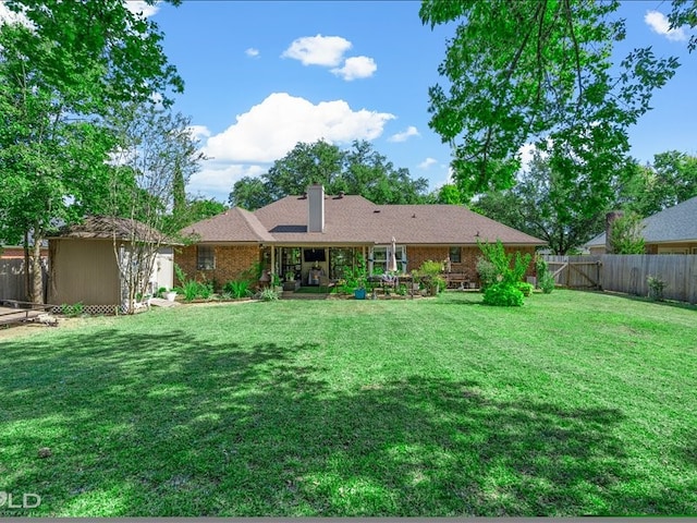 rear view of house with a yard and a patio area