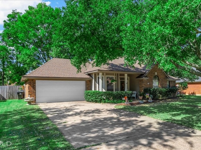 single story home featuring a front yard and a garage