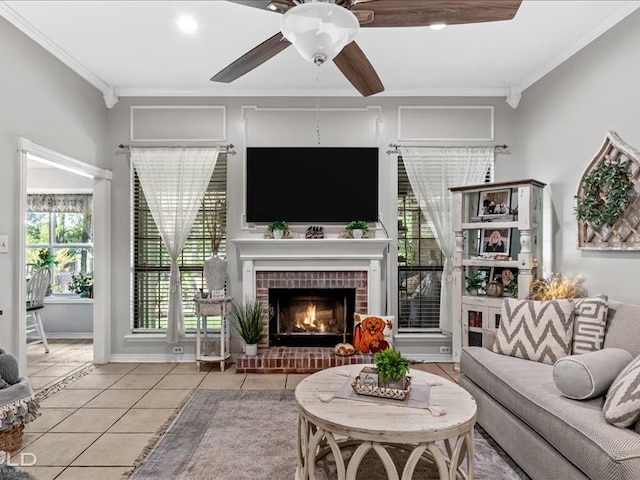 tiled living room featuring a brick fireplace, a healthy amount of sunlight, and crown molding