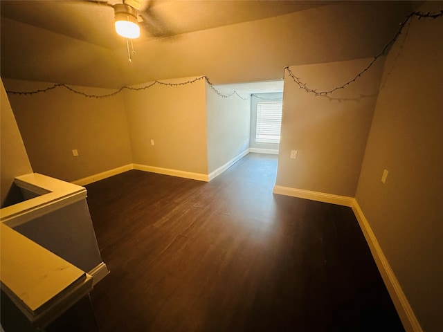 additional living space featuring lofted ceiling, dark hardwood / wood-style floors, and ceiling fan