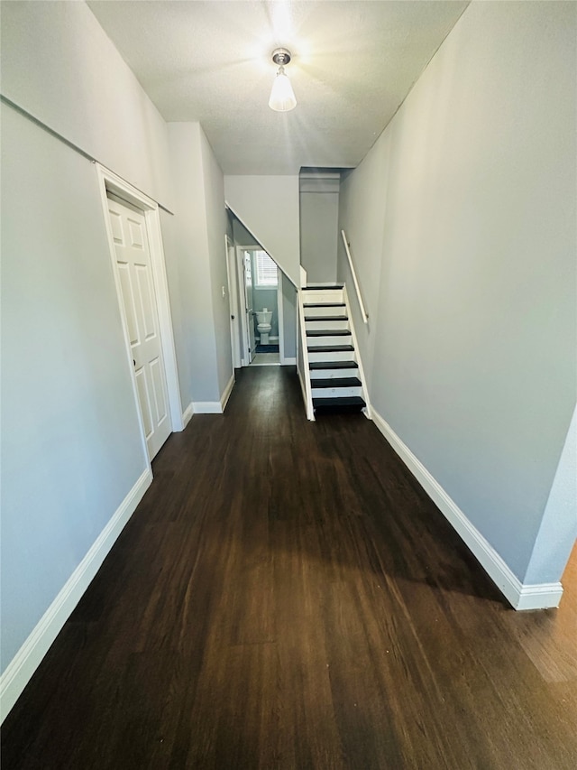 corridor featuring dark hardwood / wood-style floors