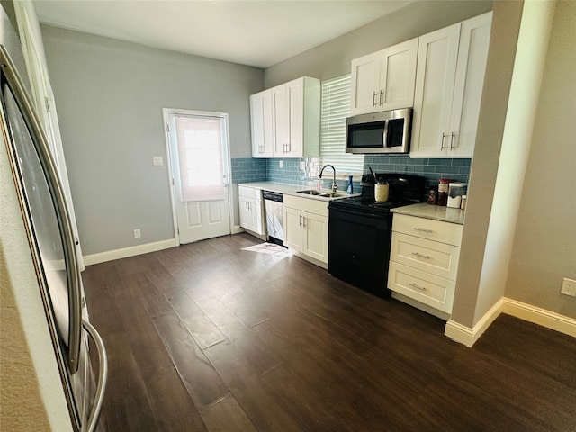 kitchen with sink, appliances with stainless steel finishes, dark hardwood / wood-style flooring, and white cabinetry