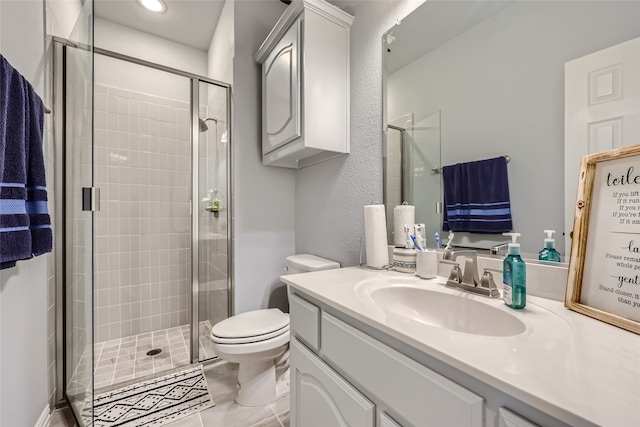 bathroom featuring vanity, toilet, an enclosed shower, and tile patterned floors