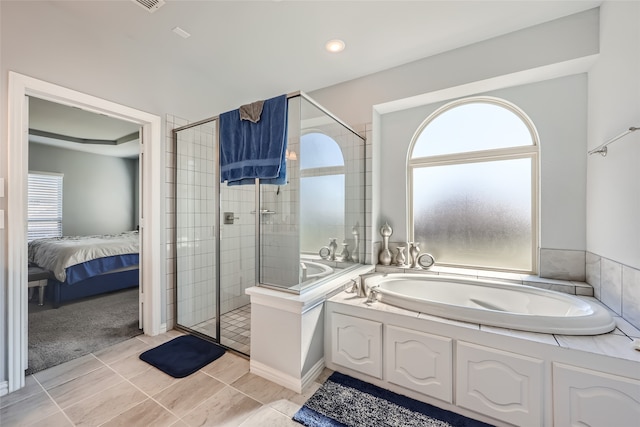 bathroom featuring separate shower and tub and tile patterned floors