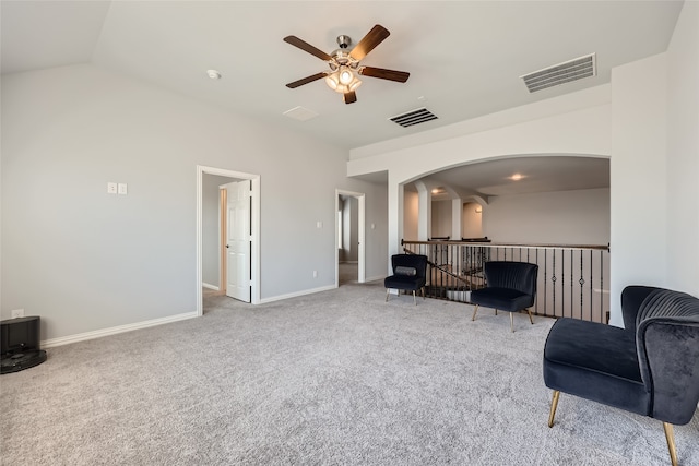 sitting room with lofted ceiling, ceiling fan, and carpet floors