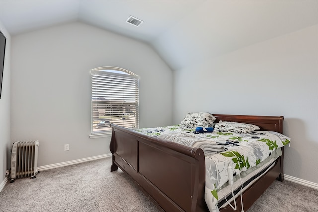 carpeted bedroom with lofted ceiling and radiator