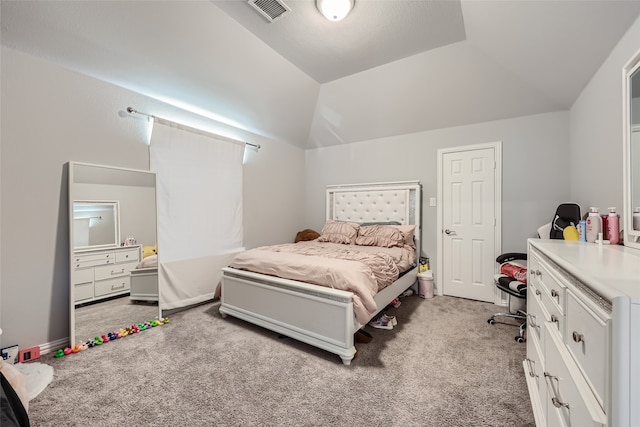 bedroom featuring lofted ceiling and light carpet