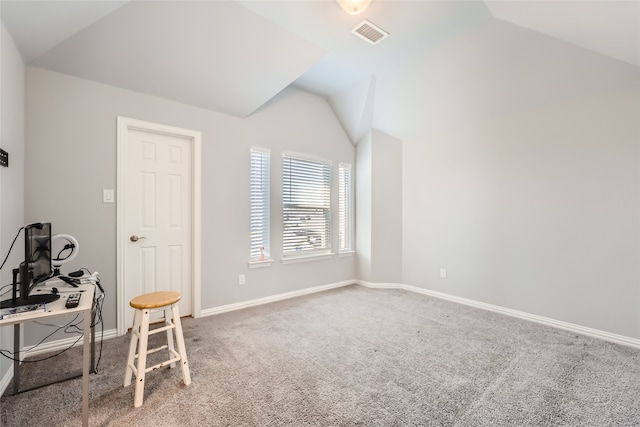 interior space featuring carpet floors and vaulted ceiling