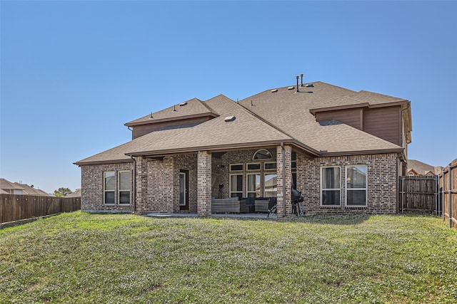 rear view of property with a yard and a patio area