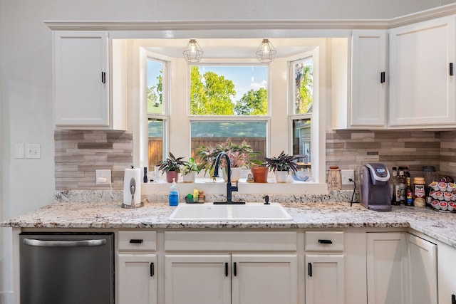 kitchen with a healthy amount of sunlight, white cabinetry, and sink