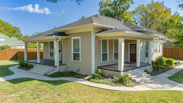 bungalow-style home with a front yard and covered porch