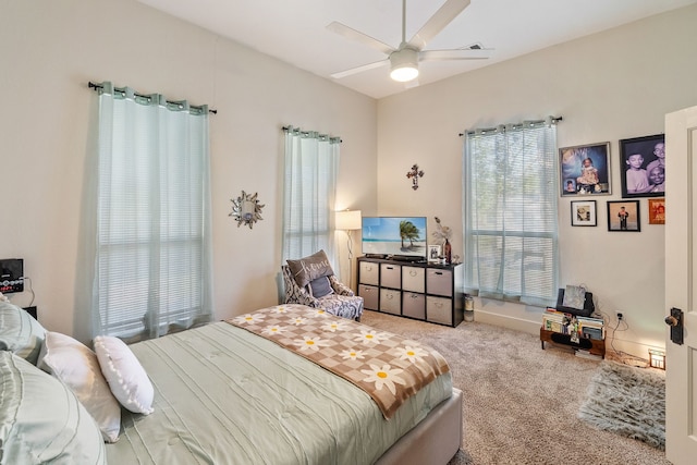 bedroom featuring light colored carpet and ceiling fan