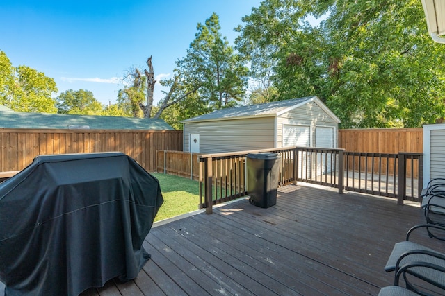 deck with a yard, a storage shed, and grilling area