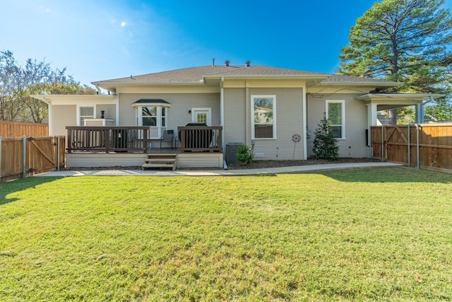 back of property featuring a deck and a yard