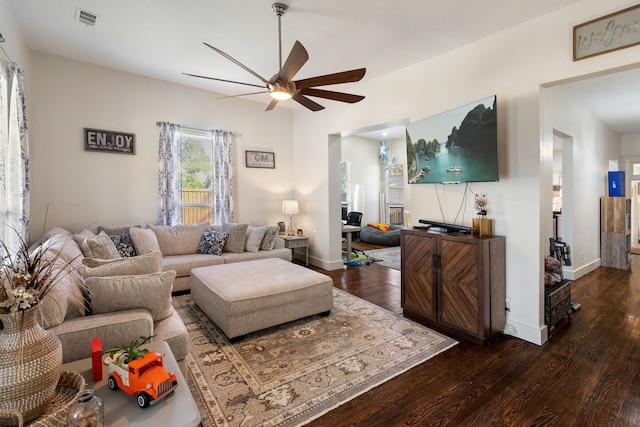 living room with dark hardwood / wood-style floors and ceiling fan