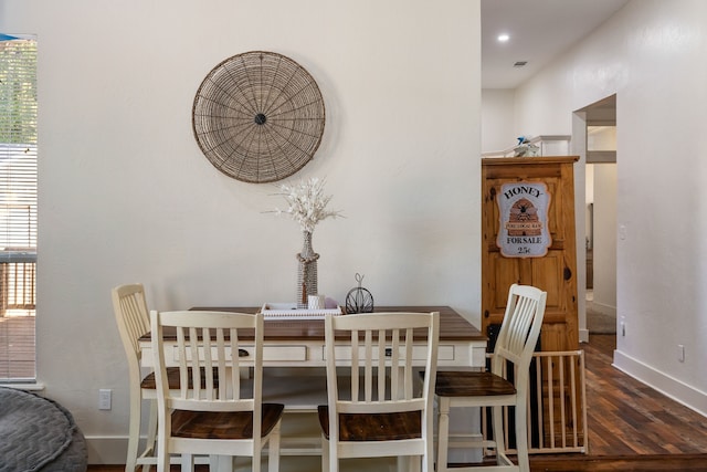 dining area featuring dark wood-type flooring