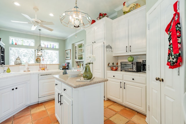 kitchen featuring white cabinets, hanging light fixtures, decorative backsplash, and a center island