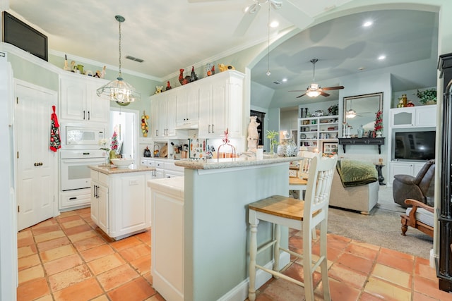 kitchen featuring a center island, white appliances, kitchen peninsula, pendant lighting, and white cabinetry