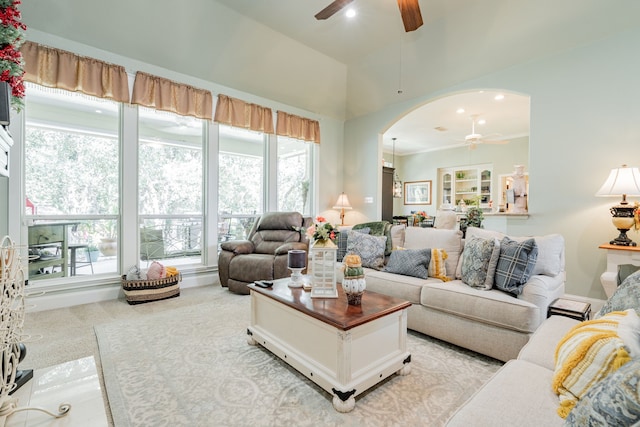 living room featuring ornamental molding, a wealth of natural light, and ceiling fan