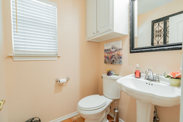 bathroom featuring sink, toilet, and tile patterned floors