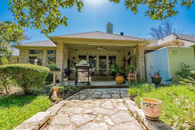 back of house featuring ceiling fan and a patio area