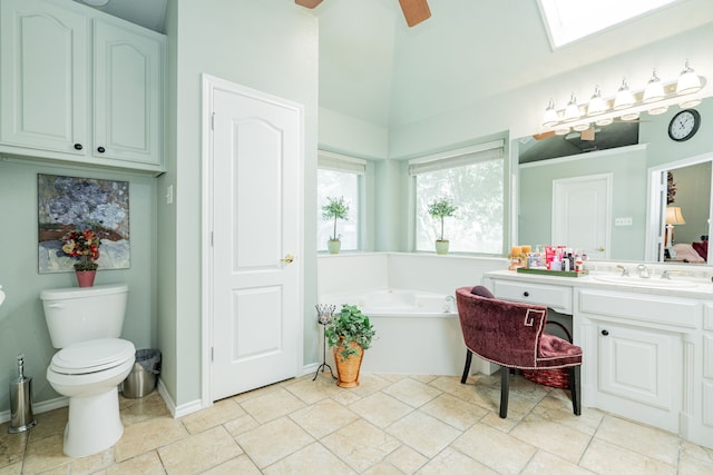 bathroom with ceiling fan, a tub to relax in, toilet, and vanity