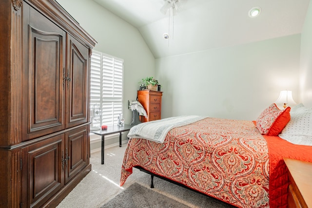 bedroom featuring lofted ceiling and light carpet