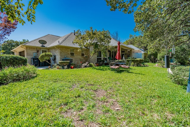 rear view of property with a lawn