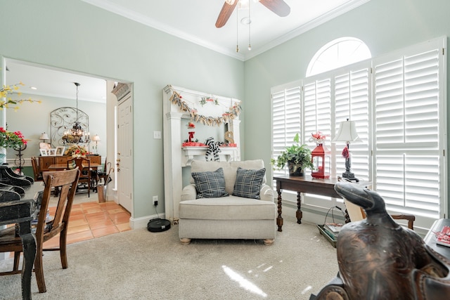 living area with ceiling fan, crown molding, and carpet flooring