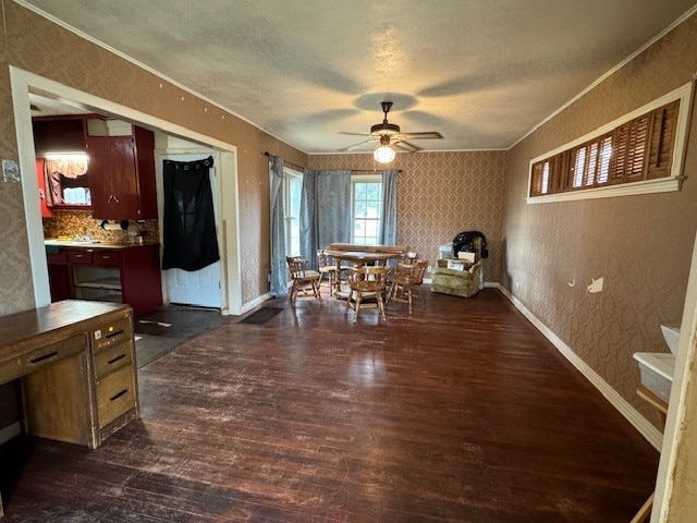 dining area featuring a textured ceiling, crown molding, dark hardwood / wood-style floors, and ceiling fan