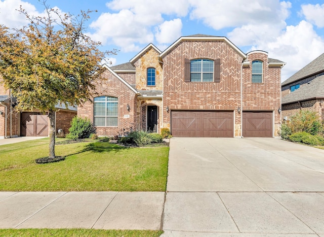 view of front of house featuring a front yard and a garage