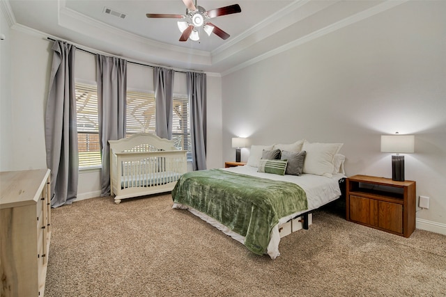 bedroom featuring carpet flooring, a raised ceiling, ceiling fan, and crown molding