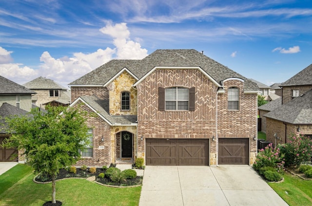 view of front of home with a front yard and a garage