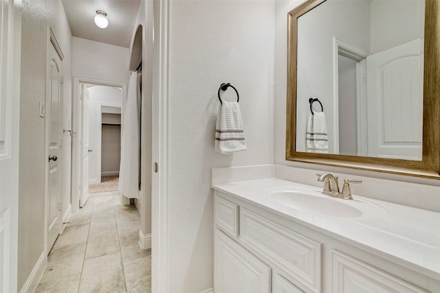 bathroom featuring tile patterned flooring and vanity