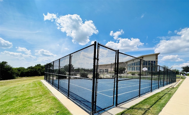 view of sport court with a yard