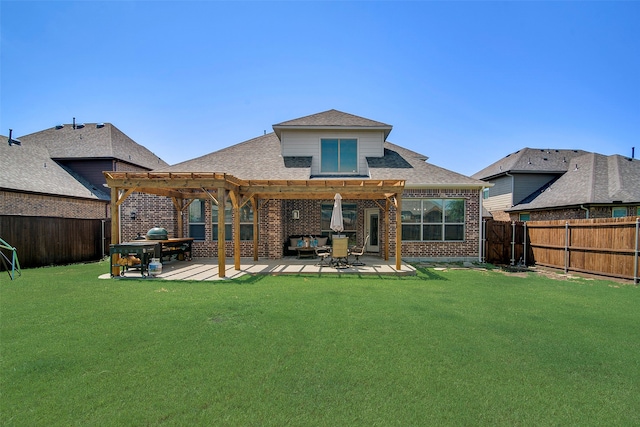 rear view of property with a pergola, a patio area, and a yard