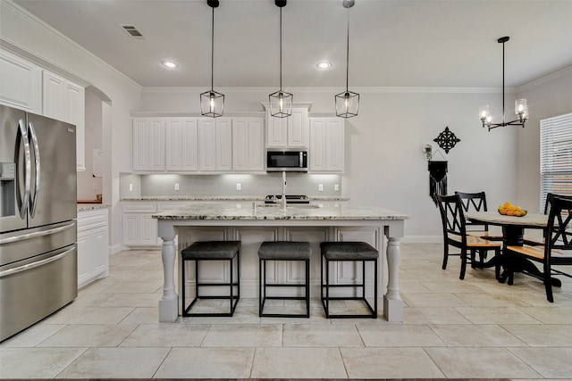 kitchen with white cabinetry, pendant lighting, an island with sink, and stainless steel appliances