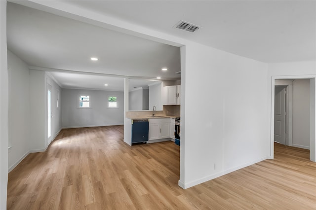 kitchen with white cabinetry, black dishwasher, stove, sink, and light hardwood / wood-style flooring