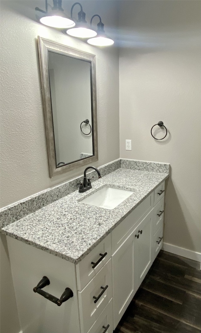 bathroom featuring hardwood / wood-style flooring and vanity