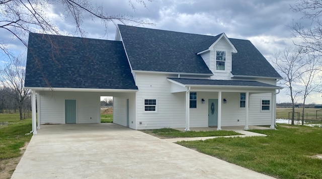 view of front of home with a front yard, a shingled roof, and concrete driveway