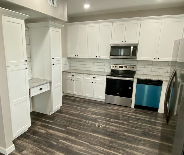 kitchen with stainless steel appliances, dark wood-style floors, white cabinetry, and backsplash