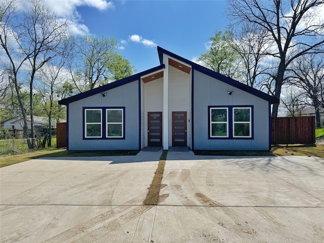 mid-century inspired home featuring fence
