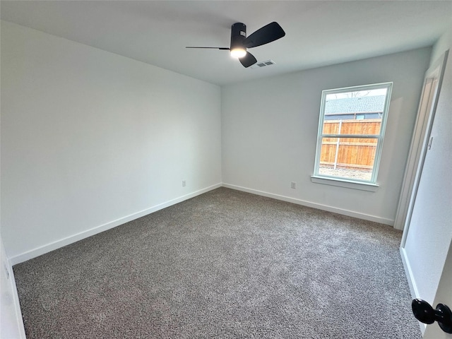 unfurnished room featuring a ceiling fan, visible vents, baseboards, and carpet flooring