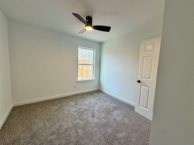 carpeted spare room featuring ceiling fan and baseboards