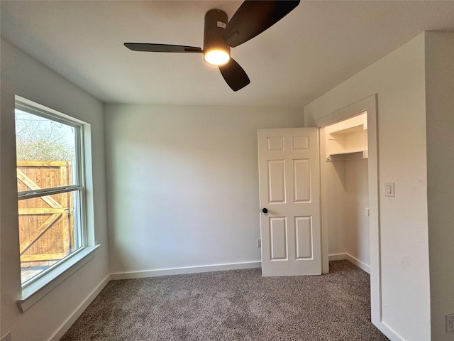 unfurnished bedroom with a ceiling fan, carpet flooring, and baseboards