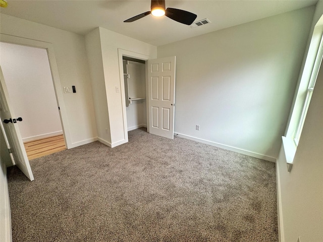 unfurnished bedroom featuring carpet floors, visible vents, baseboards, and a ceiling fan