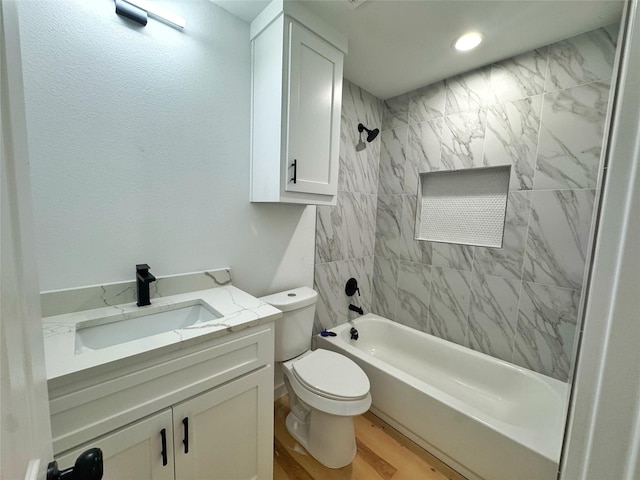 full bathroom featuring toilet, shower / washtub combination, wood finished floors, and vanity