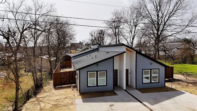 view of outbuilding featuring fence